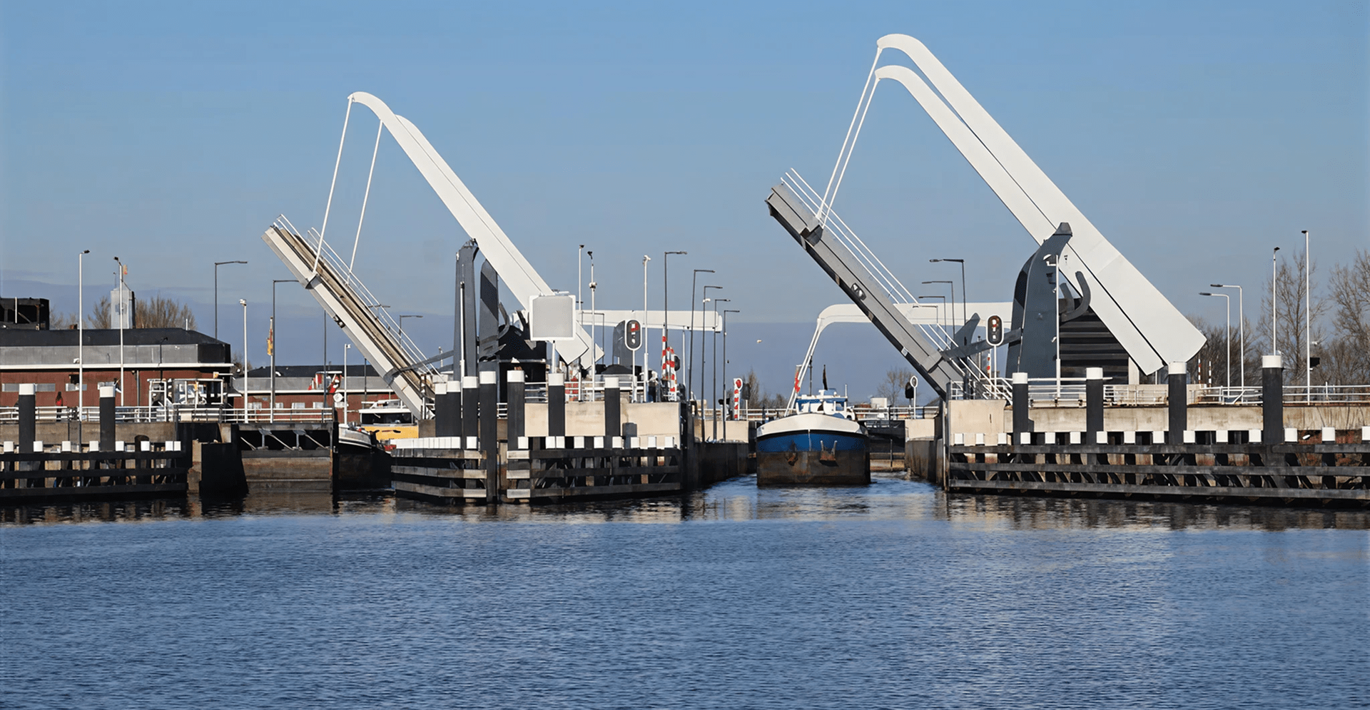 A large white bridge spans across a river